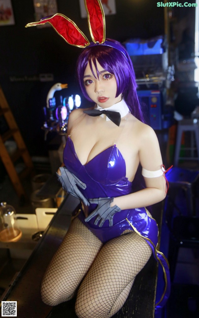 A woman in a bunny costume sitting on a table.